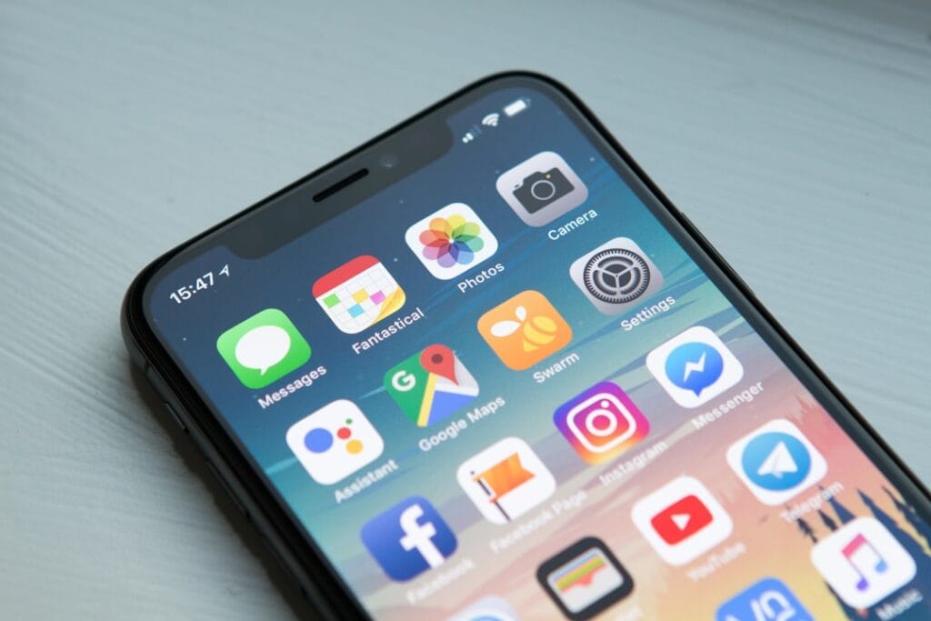 Google Drive Share Folder: Setup & Permissions iPhone X showing a colorful app home screen, representing the Google Drive mobile app for sharing folders on iOS and Android.