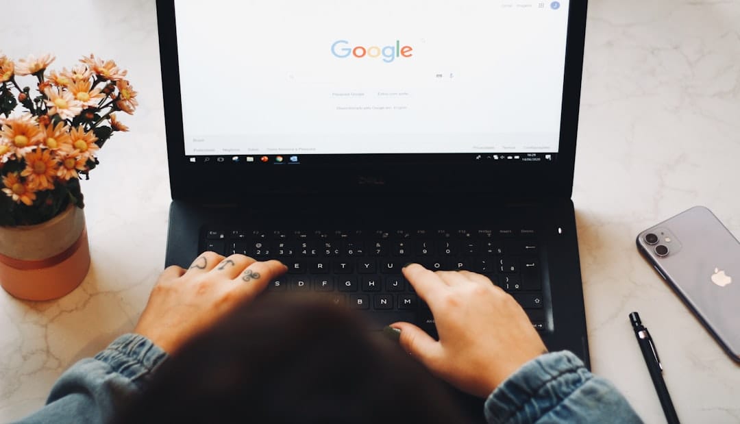 Google Drive Share Folder: Setup & Permissions Person using a laptop with the Google homepage open, representing Google Drive folder sharing. Photo by Unsplash.