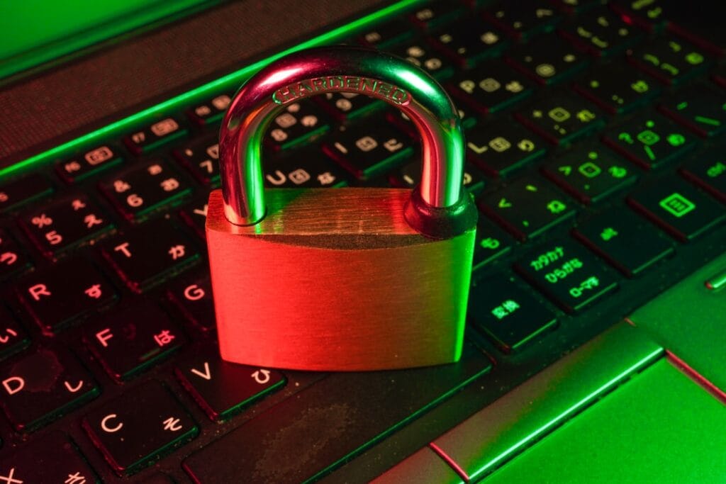 Google Drive Share Folder: Setup & Permissions A red-lit padlock on a glowing keyboard, representing revoking Google Drive folder access and locking down shared files.
