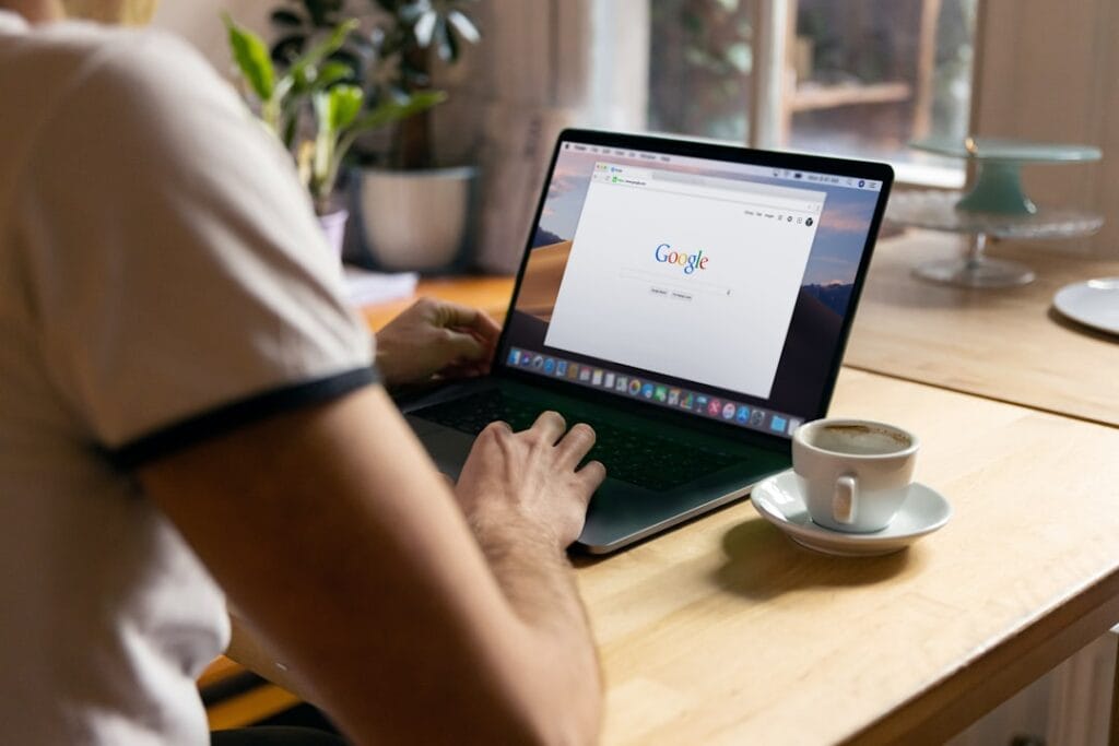 How to Share Videos on Google Drive (Full Guide) Person using a MacBook with Google open in the browser, ready to navigate Google Drive sharing settings.