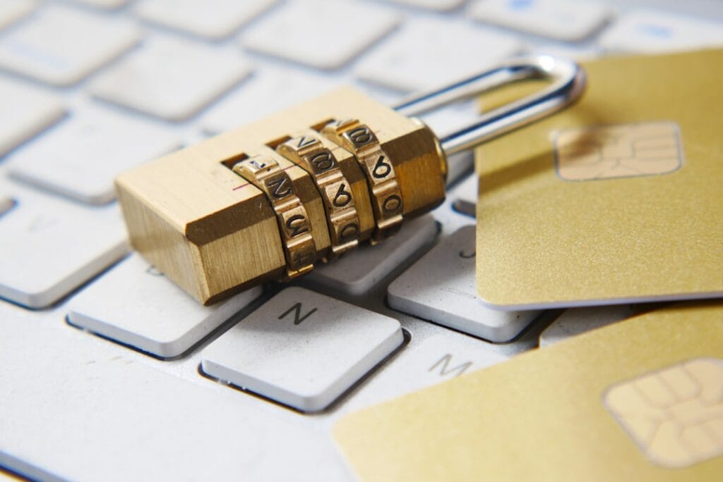 Google Drive Share Folder: Setup & Permissions A combination padlock and credit cards resting on a keyboard, symbolizing Google Drive permission levels and access control.