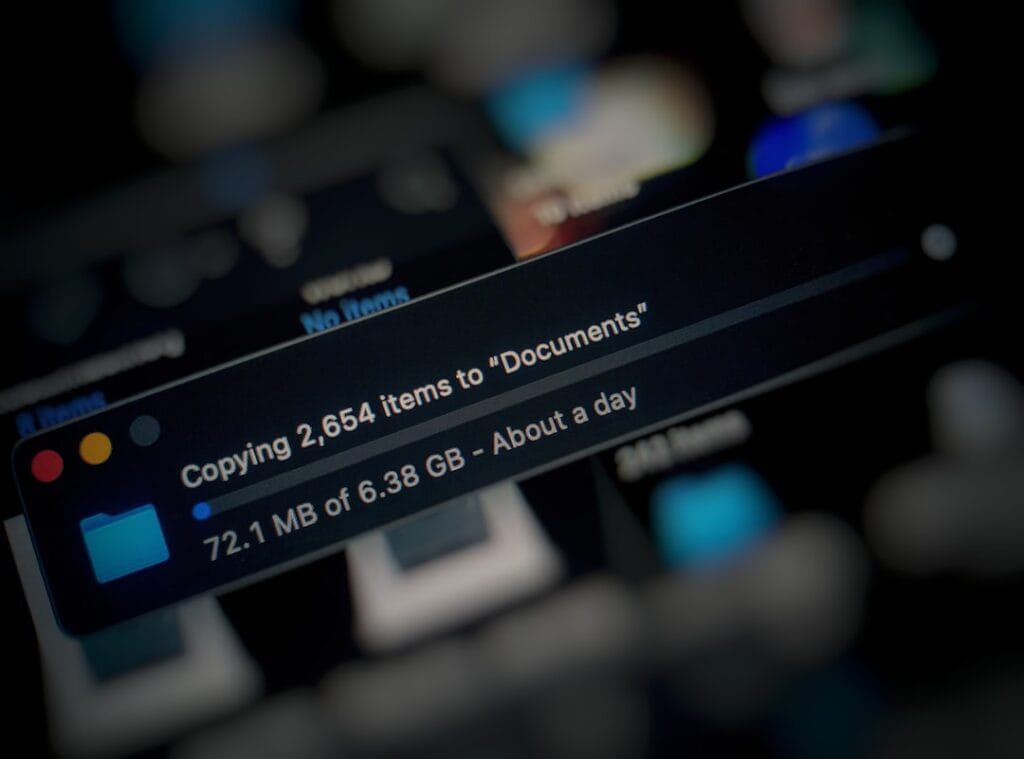 Google Docs Download: Every Export Format (2026) Mac computer screen showing a bulk file copy dialog — copying thousands of items to a Documents folder