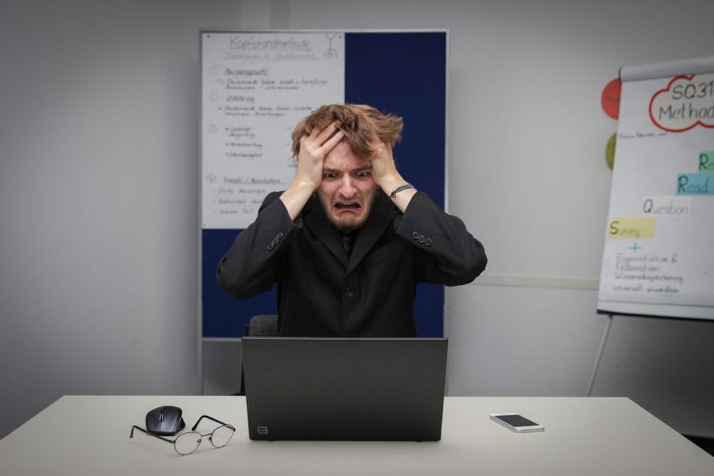 Person frustrated at laptop after hitting a Google Drive download quota error
